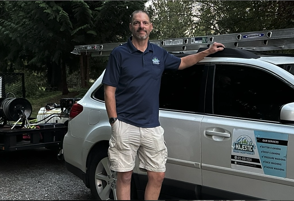 Walter King, founder of Majestic Wash Northwest, standing next to company vehicle
